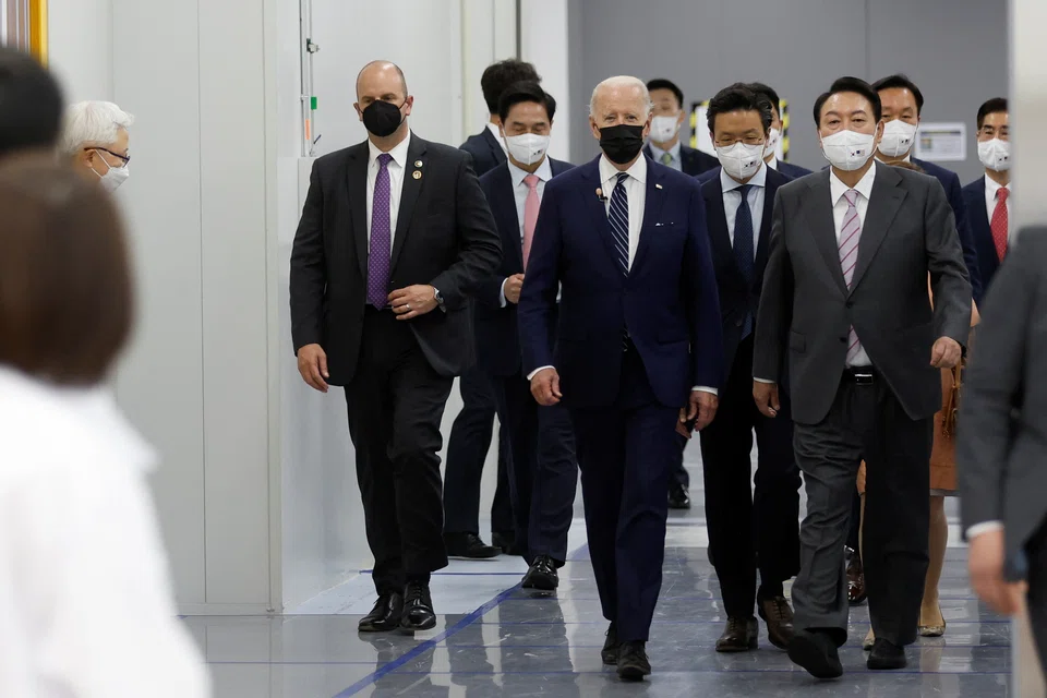 US President Joe Biden walks with South Korean President Yoon Suk-yeol (R) and Samsung Electronics Vice Chairman Jay Y Lee  during a tour of a semiconductor factory at the Samsung Electronics Pyeongtaek Campus in Pyeongtaek, South Korea.