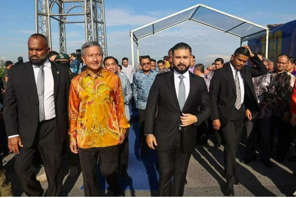 Minister for Foreign Affairs Vivian Balakrishnan (left) and the Regent of Johor, Tunku Ismail, during the commemoration ceremony held at the midpoint of the Causeway on Jun 28. 
