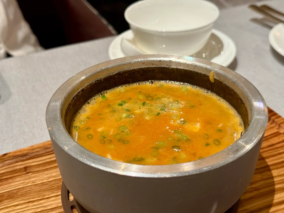 Piping hot lobster broth with rice.