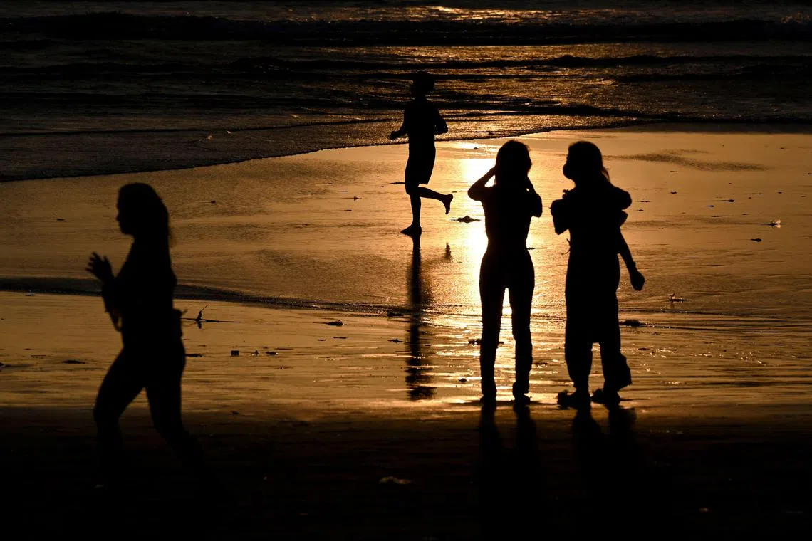 Beachgoers in Bali. Indonesia has committed to prioritising sustainability in its tourism industry.