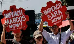 Protesters on Monday (Feb 2) hold signs calling for the impeachment of Philippine President Ferdinand Marcos Jr., and Vice-President Sara Duterte during a rally outside the House of Representatives (HOR) in Manila.