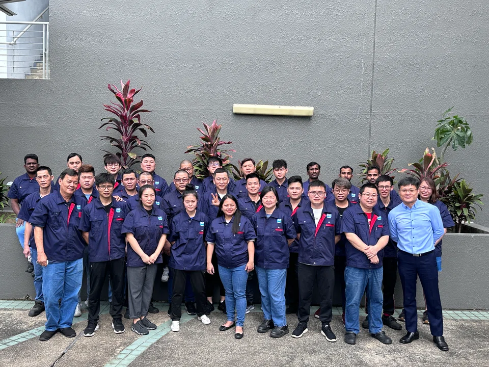 Jade Micron chief executive officer Jeff Wang (front row, extreme right) with his employees. Employee satisfaction and retention are key priorities for the company, said Wang.