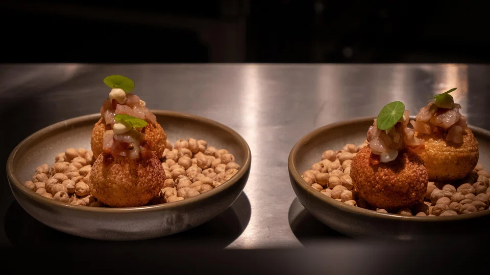 Light and airy smoked trout donuts are served with a Thai-style dressing.