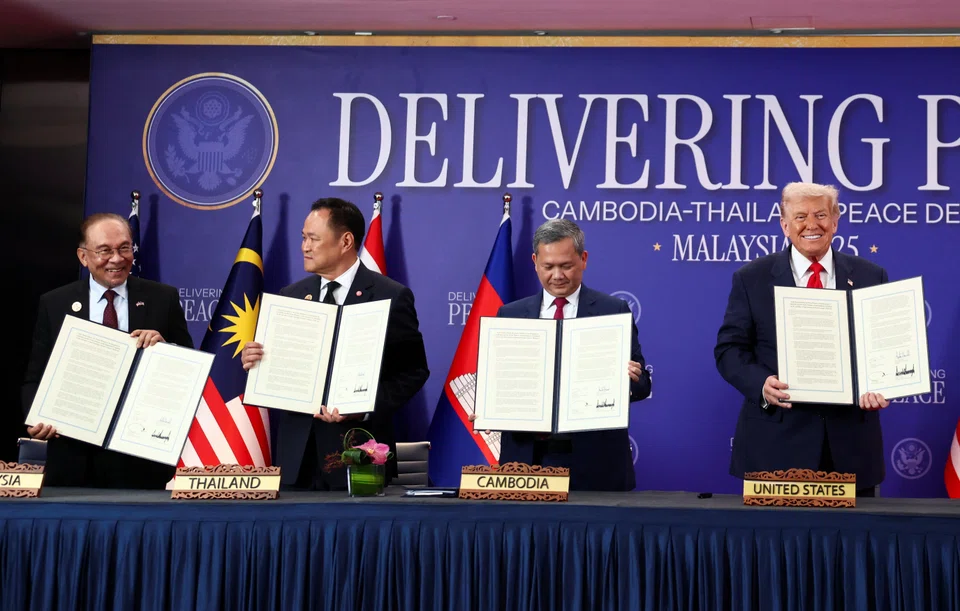 Malaysia's Prime Minister Anwar Ibrahim, Thailand's Prime Minister Anutin Charnvirakul, Cambodia's Prime Minister Hun Manet and US President Donald Trump hold up documents during the signing of a ceasefire deal between Cambodia and Thailand on the sidelines of the 47th  Asean summit in Kuala Lumpur.