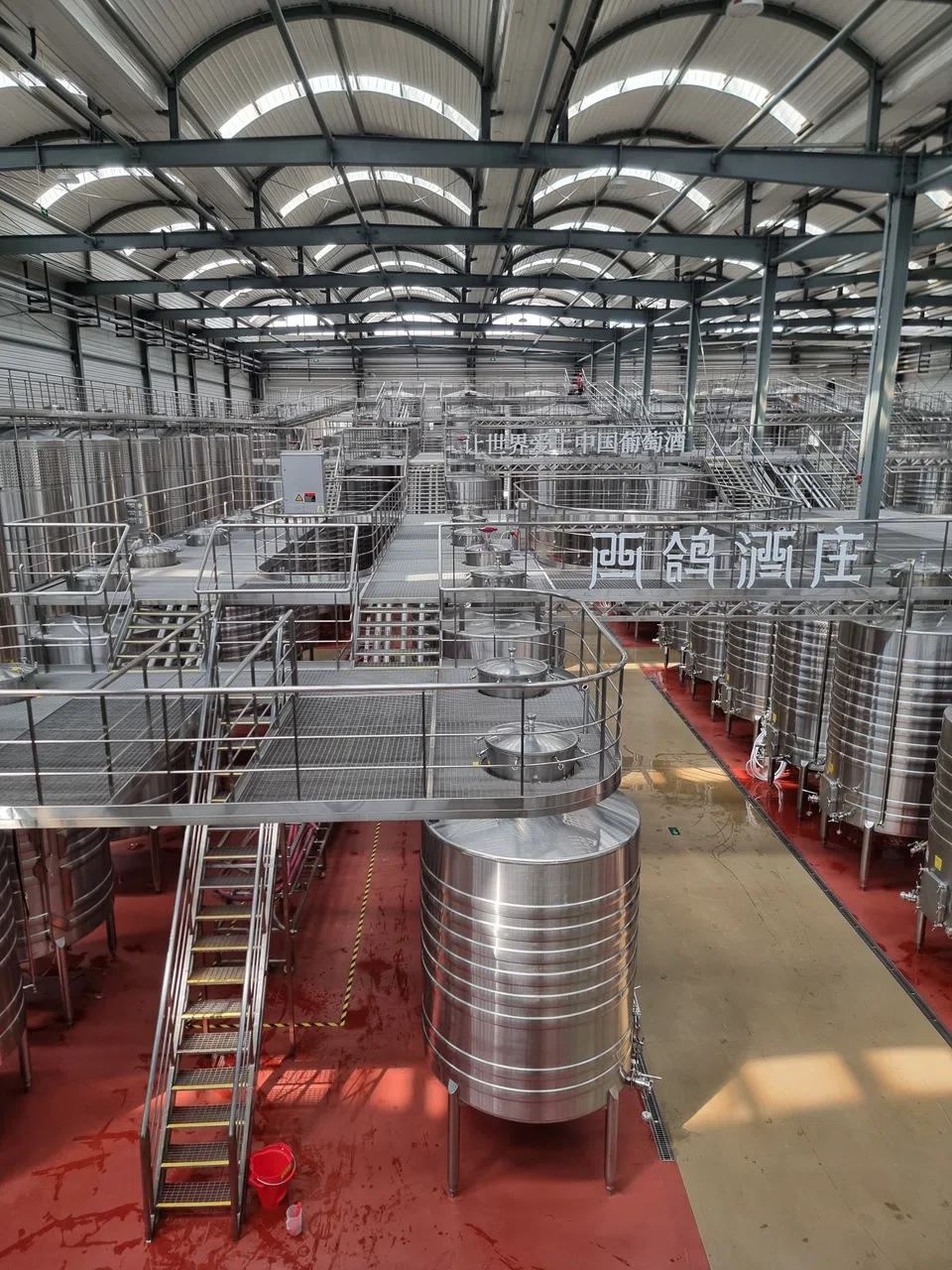 The massive rows of stainless steel tanks in Xige Estate.