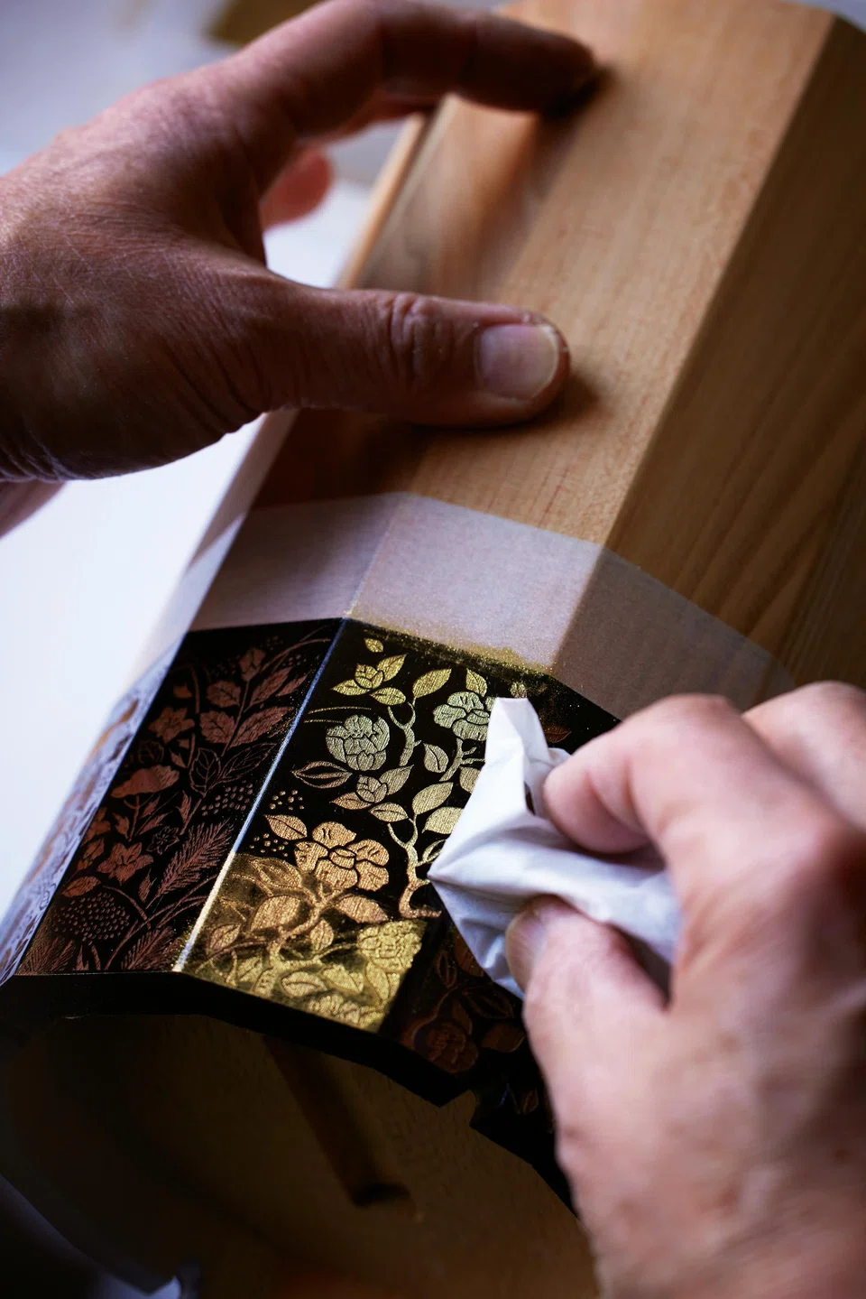 The wooden box housing the whisky is made from 12 different types of Japanese wood and features intricate designs.
