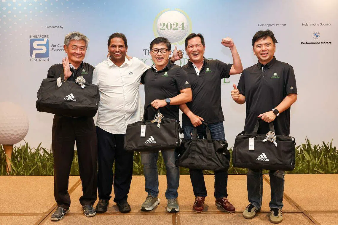 Singapore Pools players in black T-shirts (from left) Lee How Sheng, Tay Boon Khai, Francis Wan and Kevin Pang are all smiles after receiving their prizes from organising committee chairman S Murali (second from left) at Seletar Country Club.