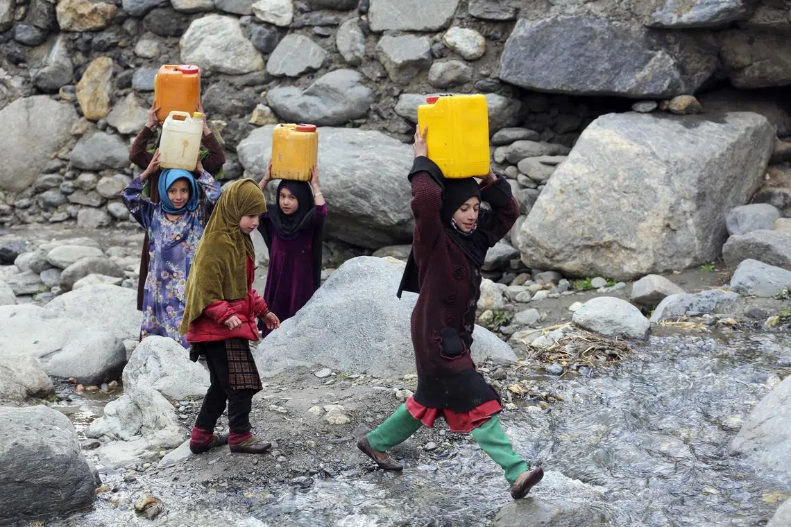 Girls carry drinking water canisters after filling from a stream in the Dara-i-Nur district of Afghanistan's Nangarhar province. Globally, billions of people still lack safe water, sanitation, and handwashing facilities, while climate change continues to amplify water-related extremes around the world. 