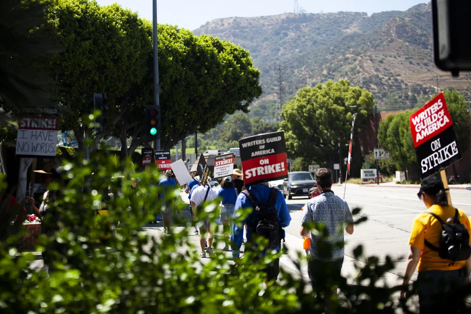 Striking members of the Writers Guild of America picket outside Walt Disney Studios in Burbank, California on Aug 3, 2023.