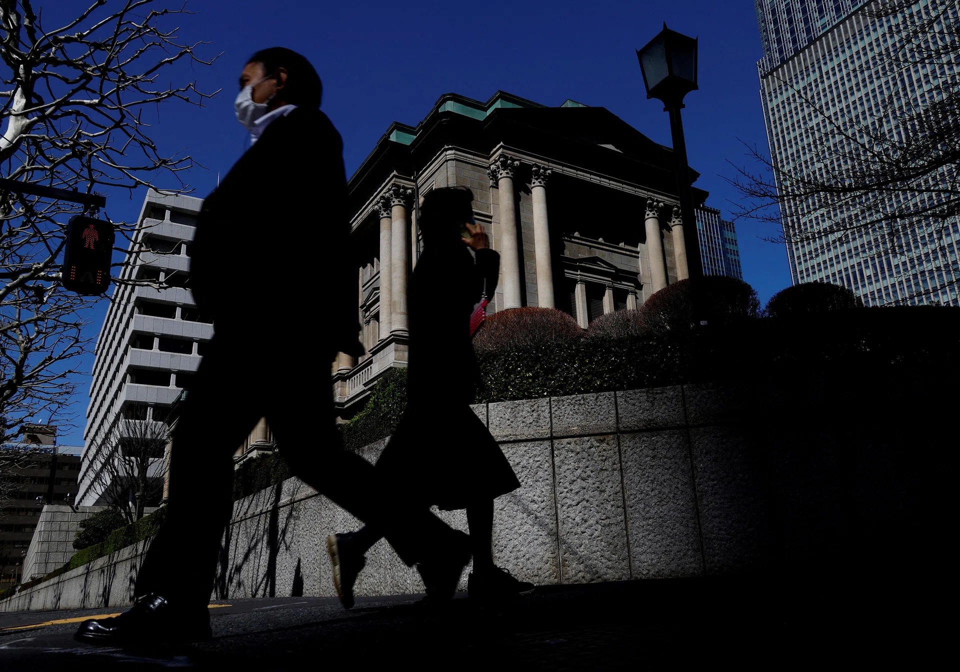 Bank of Japan raises interest rates, lays out bond taper plan - The  Business Times