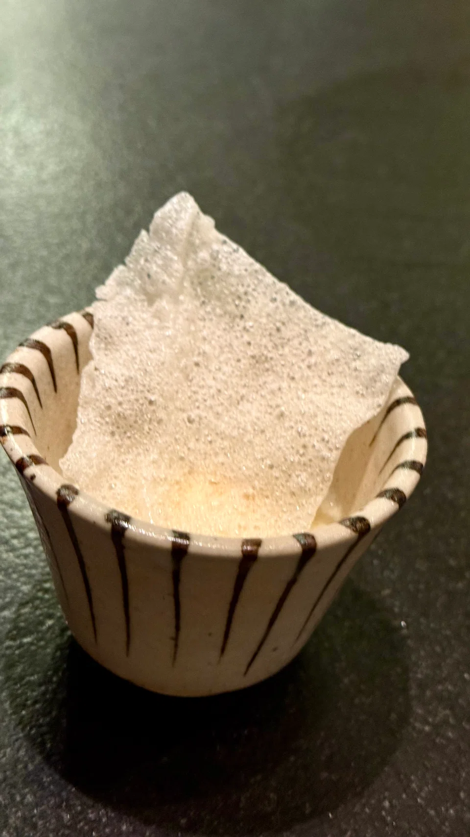 Sake lees ice cream topped with rice cracker.