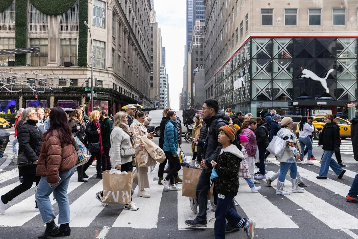 Spending spree : Shoppers throng 5th Avenue in New York City on Black Friday.
