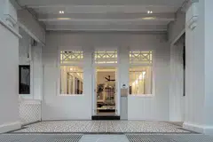 A layered entryway behind the main facade on the first storey.