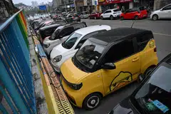 Mini EVs being charged on a street in Liuzhou, in China's Guangxi province. These tiny vehicles weave through traffic in southern China, their cheerful designs bringing a touch of colour to the EV revolution in the country. 