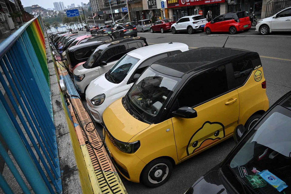 Mini EVs being charged on a street in Liuzhou, in China's Guangxi province. These tiny vehicles weave through traffic in southern China, their cheerful designs bringing a touch of colour to the EV revolution in the country. 