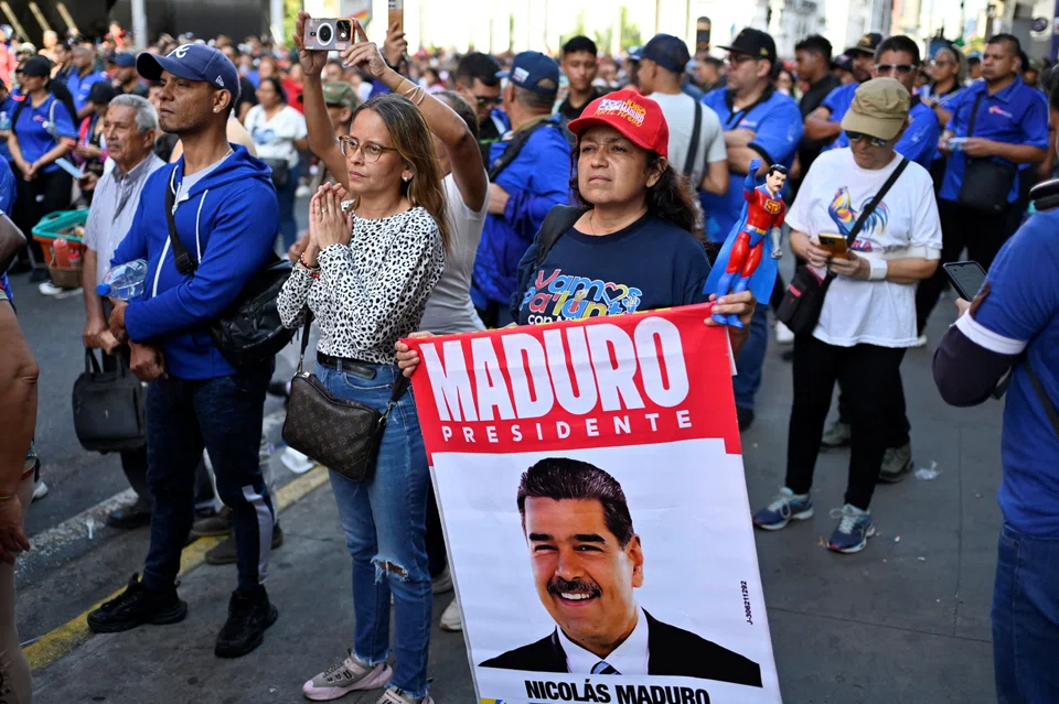 A demonstrator displays a sign with an image of Venezuelan President Nicolas Maduro during a demonstration in Caracas, Venezuela, Jan 5, 2026. 