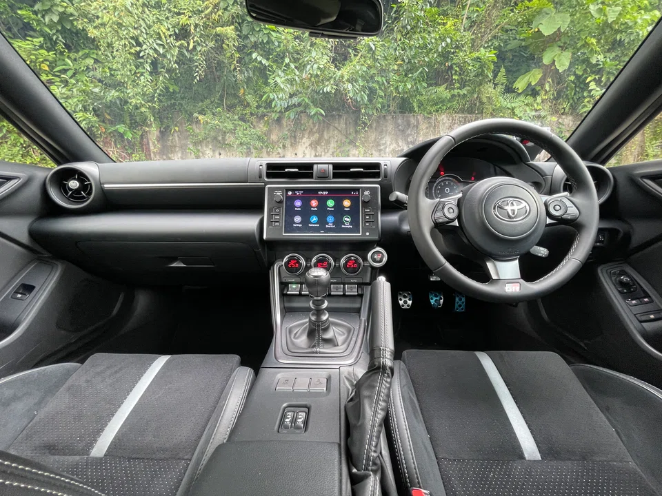 The cabin is full of toy car plastics, and the digital screens look rudimentary at best.