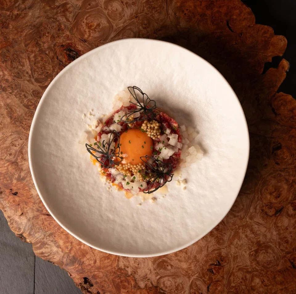 Beek yukhoe features chopped raw beef mixed with pickles and raw egg yolk.