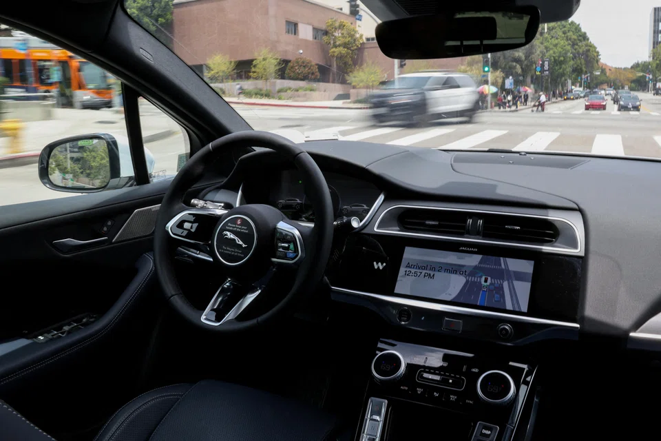 A self-driving Waymo car drives through Los Angeles, California, May 12, 2025. After years of cautious growth, Waymo has recently increased its pace, launching in new cities through partnerships with ride-hailing platforms and fleet operators.