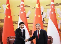 PM Lawrence Wong (left) and China's Premier Li Qiang at the Great Hall of the People in Beijing.