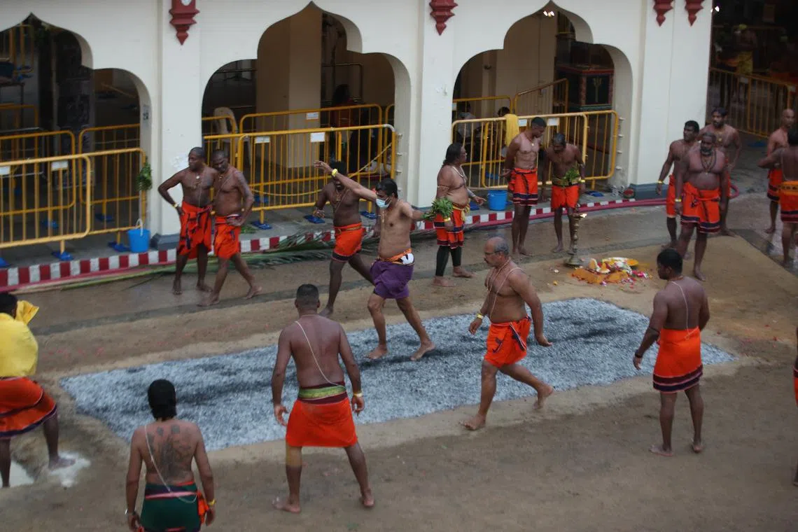 Devotees cross the "carpet" of burning embers during a fire-walking ceremony. The feat is dangerous if walkers do not know what they are doing; the same principle applies to stock investing.