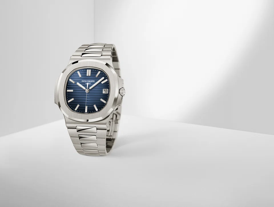 The Patek Philippe Nautilus 5811 comes in white gold and has a sunburst dial with a black gradient rim.