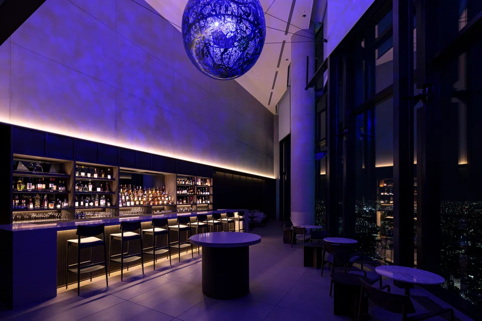 A beautfiul orb-like sphere hangs from the ceiling of Bar Bellustar.