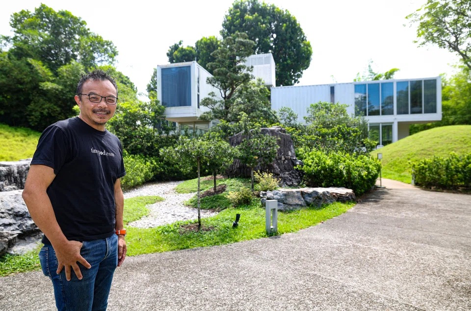 Tiny Pod's founder Seah Liang Chiang with his shipping container hotels at Gardens by the Bay. 