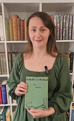 Caitlin Riley, a rare books specialist, poses with one of the first editions of The Hobbit by J.R.R. Tolkien which was discovered in a home library of a cleaned-out house in Bristol.