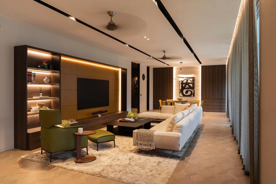 The son’s living room is embellished with a custom, dark-coloured cabinetry.