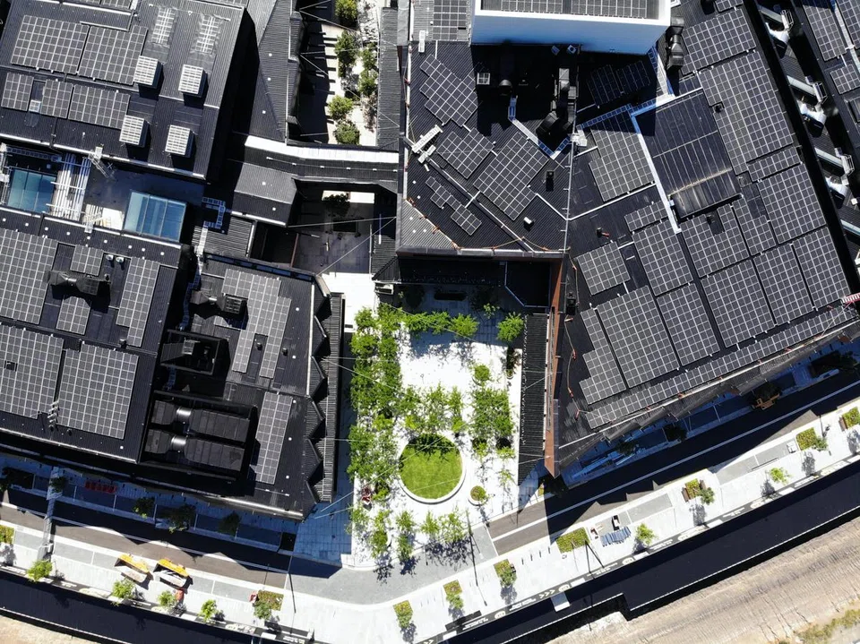 Solar panels on the roof of Frasers Property Australia’s Ed.Square Town Centre in Sydney. Frasers Property Australia would be able to achieve interest rate savings from the second year of the loan if it meets its annual emission reduction targets until it hits net-zero in 2028. 