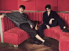 Apo (left) wears a shirt, pullover, bermuda shorts and sneakers by Dior. Miles wears a blazer, trousers and sneakers by Dior. 