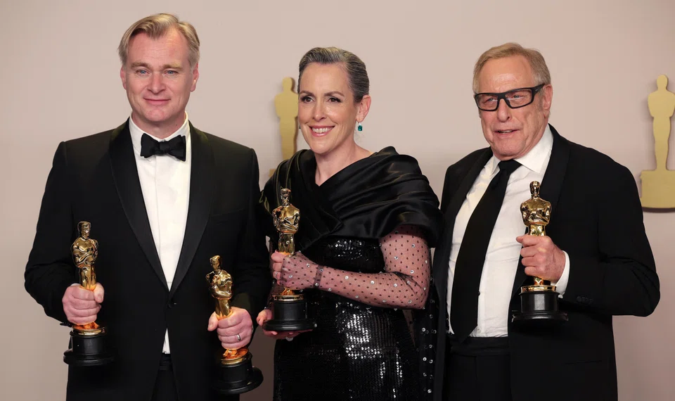Christopher Nolan, Emma Thomas and Charles Roven pose with the Oscar for best picture for Oppenheimer at the 96th Academy Awards in Hollywood.