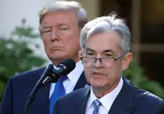 US President Donald Trump (left) and Fed chair Jerome Powell pictured in 2017.  Economists say the public pressure from Trump to cut rates has created a moral hazard for the Fed.