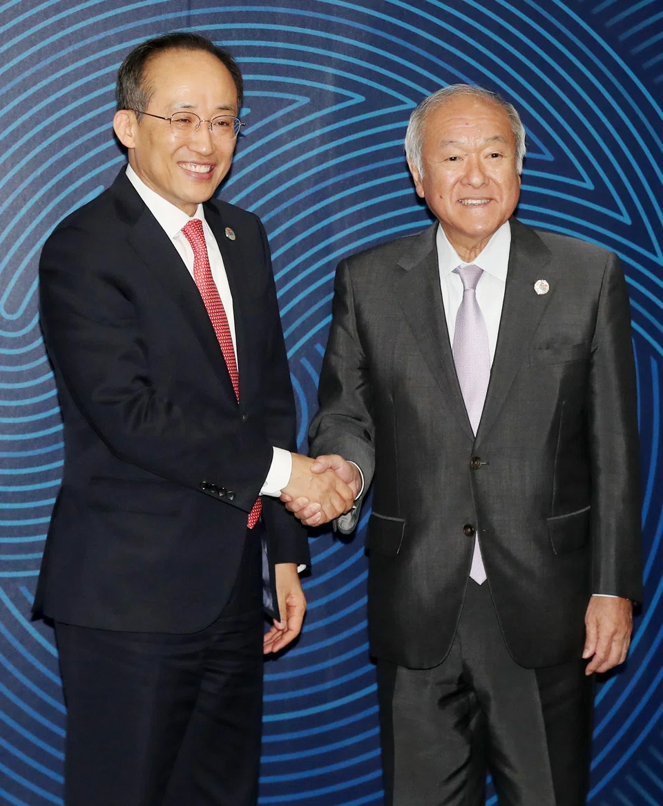 South Korean Finance Minister Choo Kyung-ho (L) and Japanese Finance Minister Shunichi Suzuki  meeting on the sidelines of this year's annual congress of the Asian Development Bank in Incheon, South Korea.