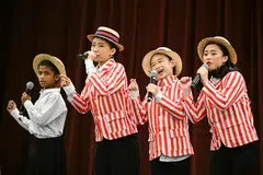 Kids in 1930s-inspired costumes performing a medley at the ChildAid dress rehearsal. 
