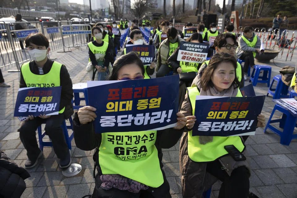 Doctor protesters hold placards reading "Stop populist medical policy", during a protest against the government's medical policy near the presidential office in Seoul, South Korea, Feb 14, 2024. 