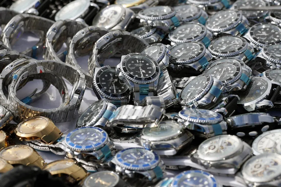 Counterfeit watches being prepared to be destroyed in Bangkok, Thailand, Aug 31, 2023. Buyers need to understand the implications of these fake goods – such as the use of toxic ingredients or child labour, for example.