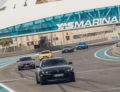 A BMW M4 Coupe leads other BMW M cars at the Yas Marina Circuit during the BMW M Experience.