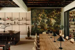 An oil painting by Asian-American painters Martin Fu and Tony Ho forms the backdrop for the dining table at This Humid House.