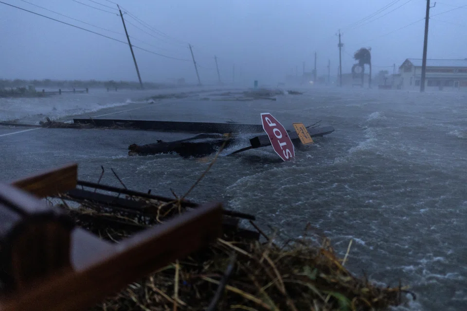 Debris and floodwaters from Hurricane Beryl cover the main roadway in Surfside Beach, Texas.