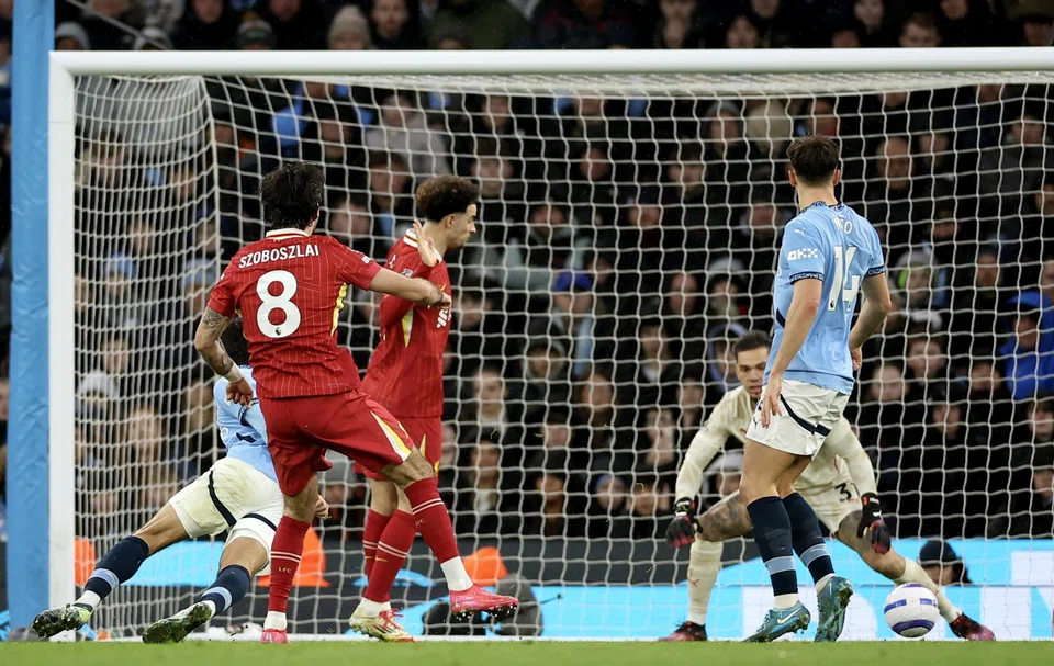 (Second from left) Dominik Szoboszlai of Liverpool scores the second goal during the English Premier League match between Manchester City and Liverpool, Manchester, Britain, Feb 23, 2025.  
