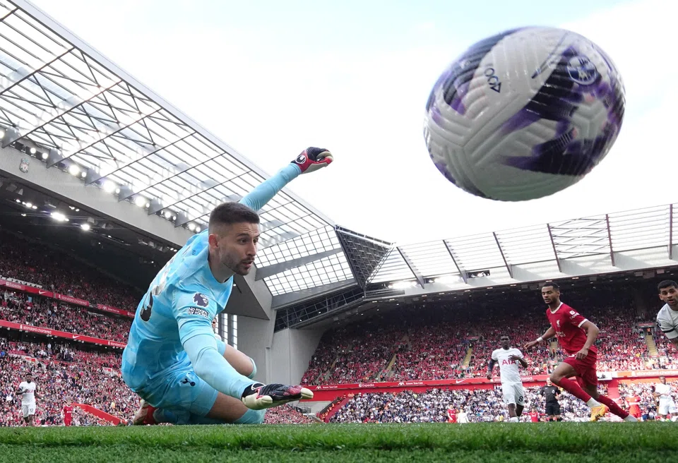 Liverpool's Cody Gakpo scores their third goal past Tottenham Hotspur's Guglielmo Vicario, Anfield, Liverpool, Britain, May 5, 2024.