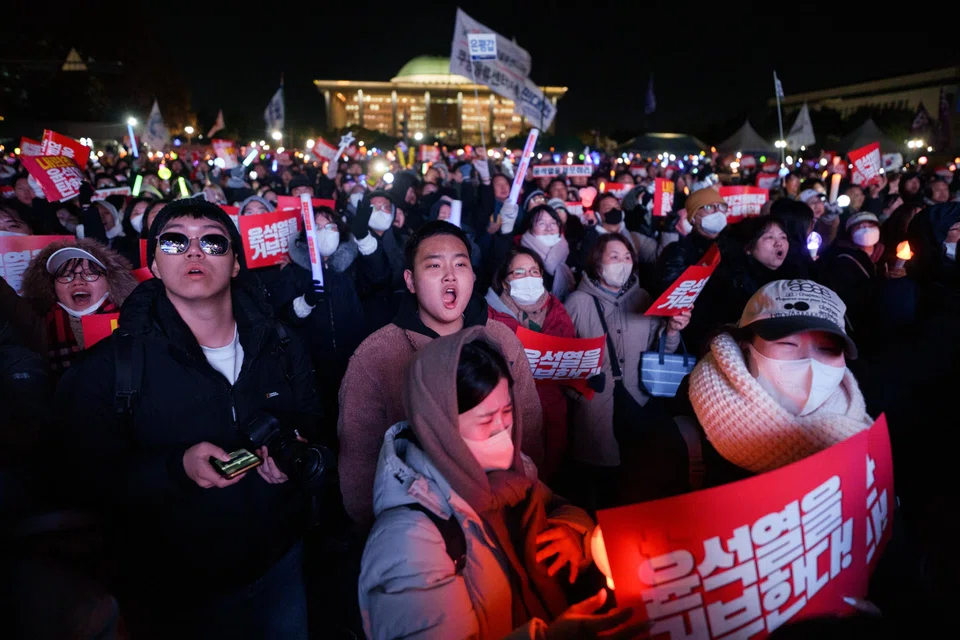 Demonstrators call for the impeachment of President Yoon Suk Yeol outside the National Assembly in Seoul, South Korea, Dec 7, 2024. 
