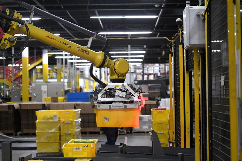 A robotic arm picks up sorting containers at an Amazon fulfillment centre in the United States.