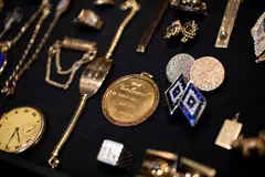 Two hundred items, including gold rings encrusted with jewels, cufflinks, watches and chains, have been brought together by GWS Auctions. Presley's former wife, Priscilla Presley, helped design some of the pieces.