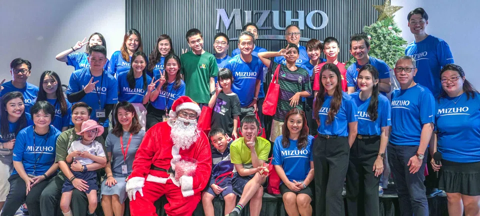 Mizuho Bank and Mizuho Securities employees together with students and staff from AWWA's Special Student Care Centre on Dec 23.