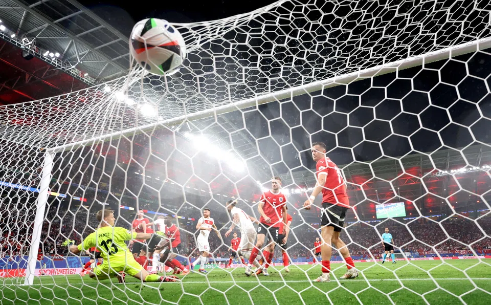 Turkey's Merih Demiral (centre) celebrates after scoring his second goal against Austria in Leipzig, Germany, July 2, 2024.  