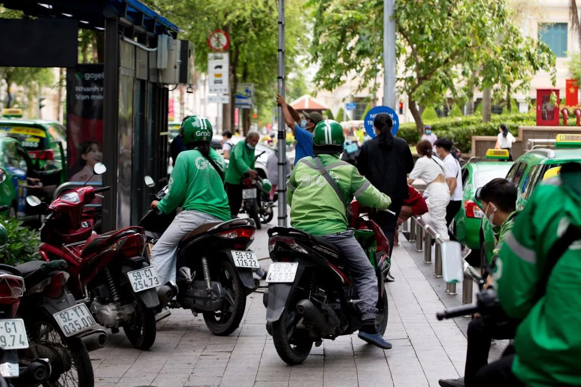 Grab riders and taxi drivers in Ho Chi Minh City, Vietnam. Consumer digital services will be one of the major growth drivers for Asean in the post-Covid future.