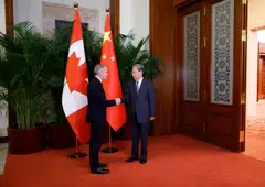 PM Carney (left) with Zhao Leji, the chairman of the Standing Committee of the National People's Congress of China, at the Great Hall of the People in Beijing on  Thursday.